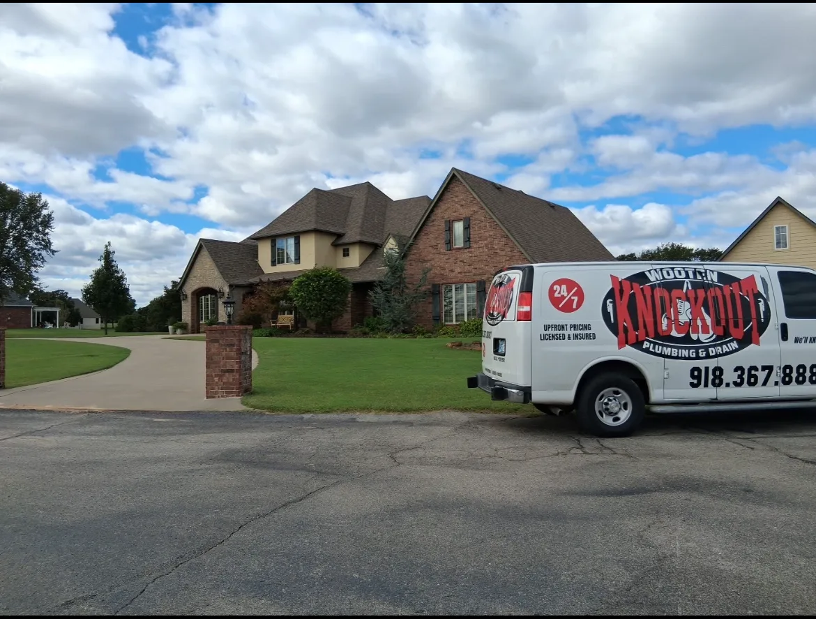 Wooten Knockout Plumbing service van outside a home