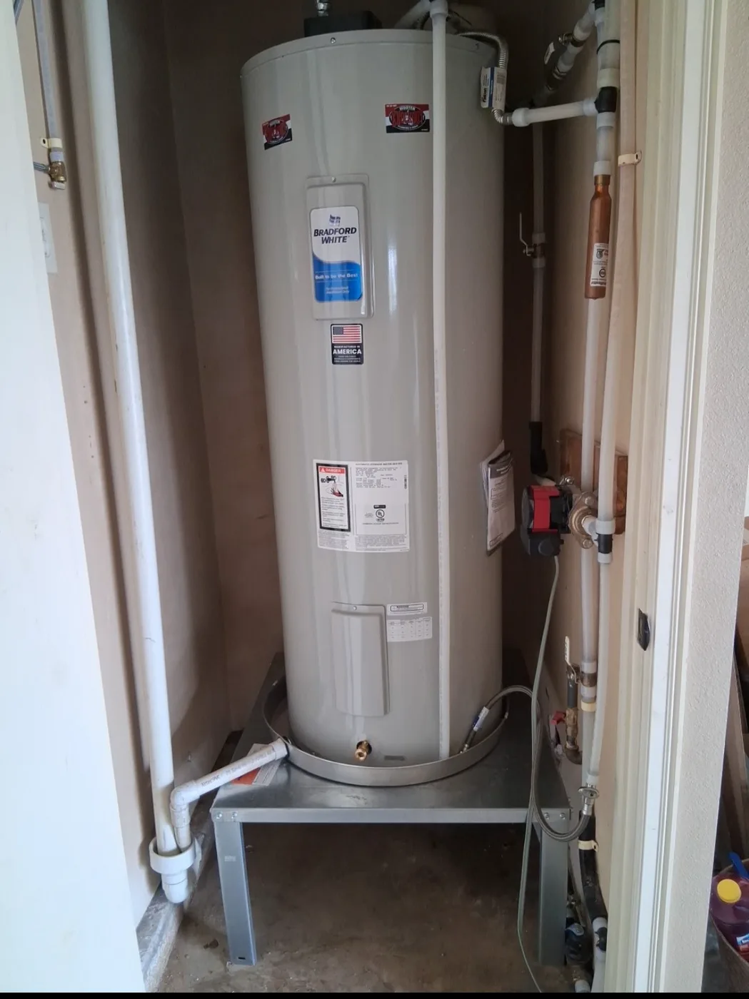 Installed tank water heater in a utility closet