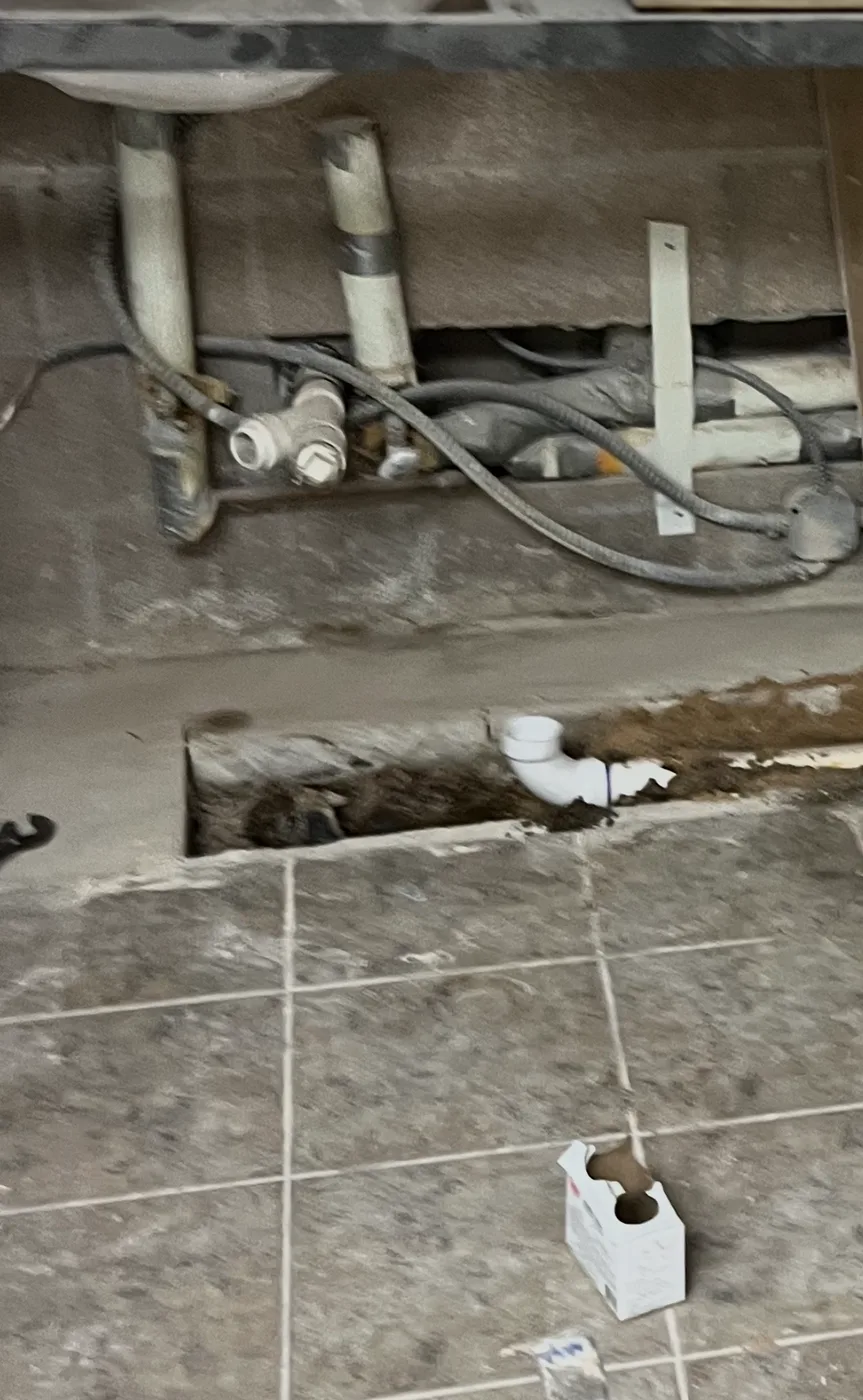 Exposed sink drain pipework during an interior plumbing repair